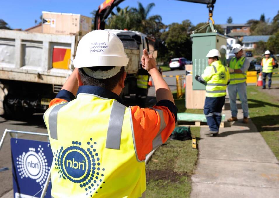 NBN Co contractors install fibre-to-the-node internet connection boxes in Cooks Hill in 2015.