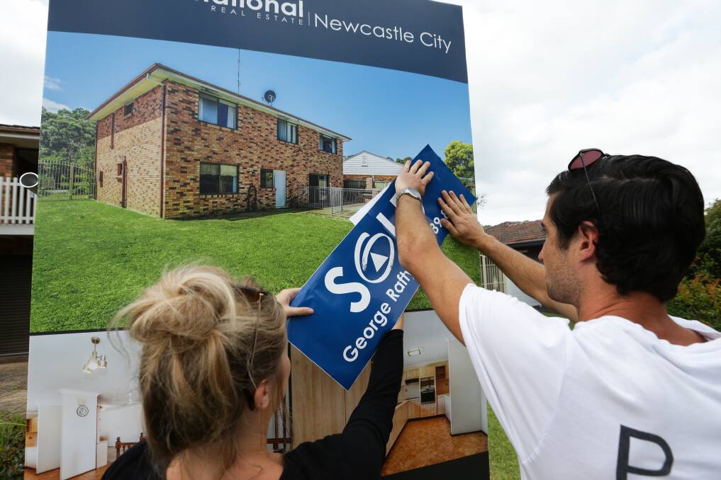 A couple secure a house in Valentine at auction in December 2020. East Lake Macquarie has recorded the highest 30-year rise in prices in the Hunter. Picture by Jonathan Carroll