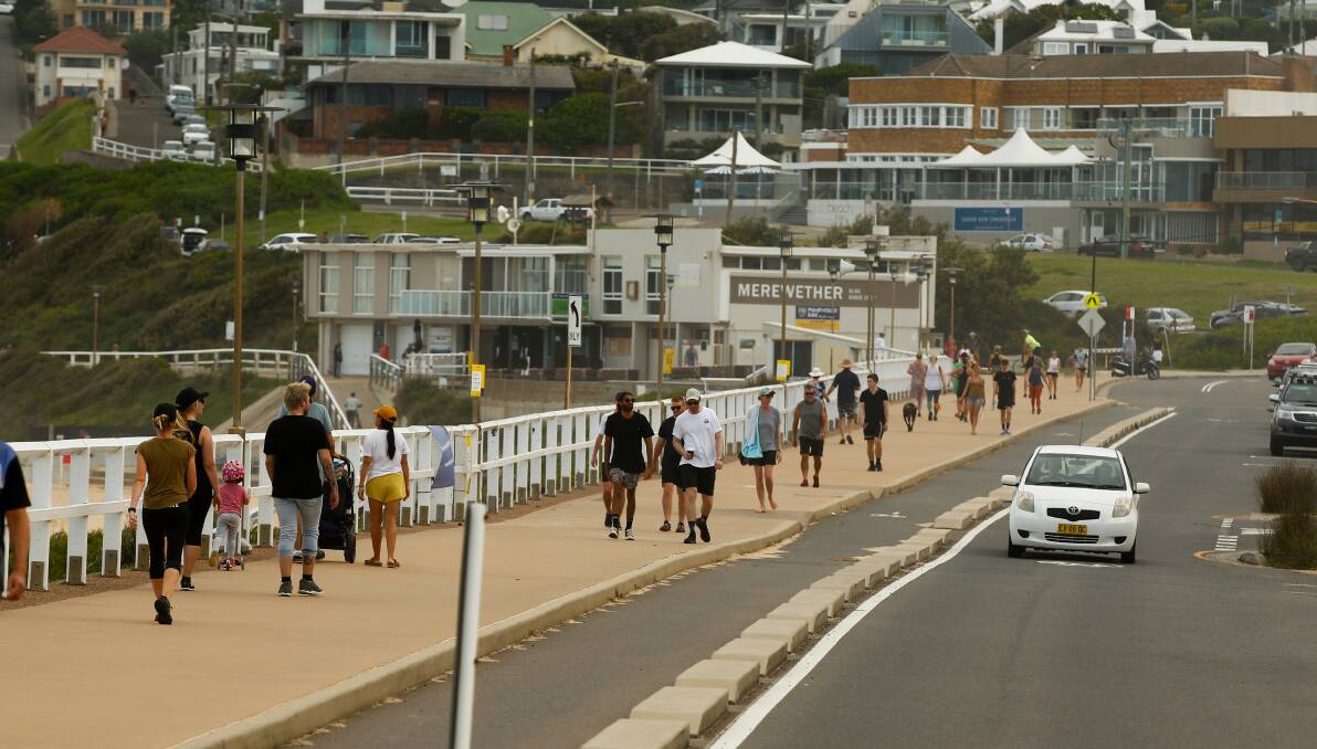QUIETER: Walkers on Bathers Way at Merewether on Monday at 1.30pm. Picture: Jonathan Carroll