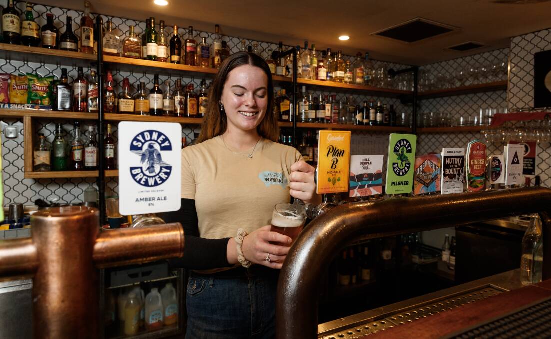 CHANGES: Renee Harris pours a beer at The Happy Wombat on Friday. Picture: Max Mason-Hubers