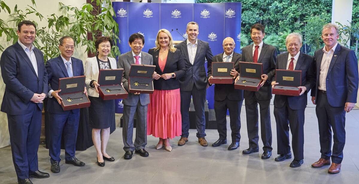 KEYS TO THE CITY: Colombo Plan scholars Bill Chua, Cheong Koon Hean, Khaw Boon Wan, Jaspal Singh, Tan Chin Nam and Peter Tay Buan Huat with Nuatali Nelmes, Port Stephens mayor Ryan Palmer, NSW Trade Minister Stuart Ayres and High Commissioner William Hodgman in Singapore on Monday.