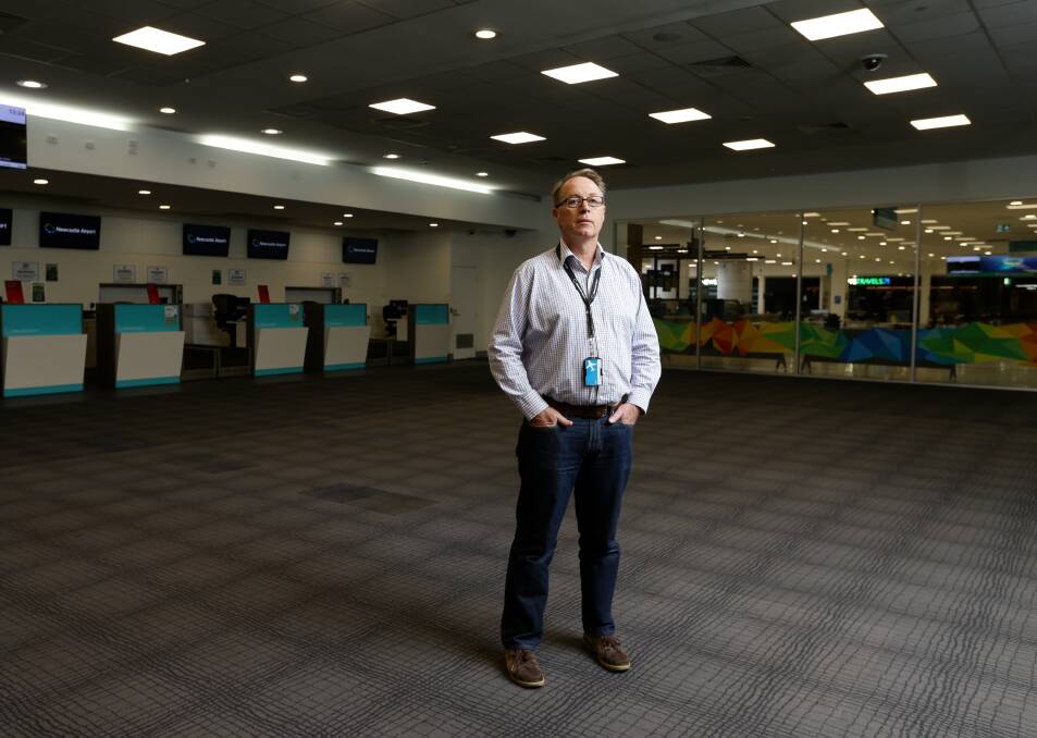 GROUNDED: Dr Peter Cock in the empty Newcastle Airport terminal in April. 