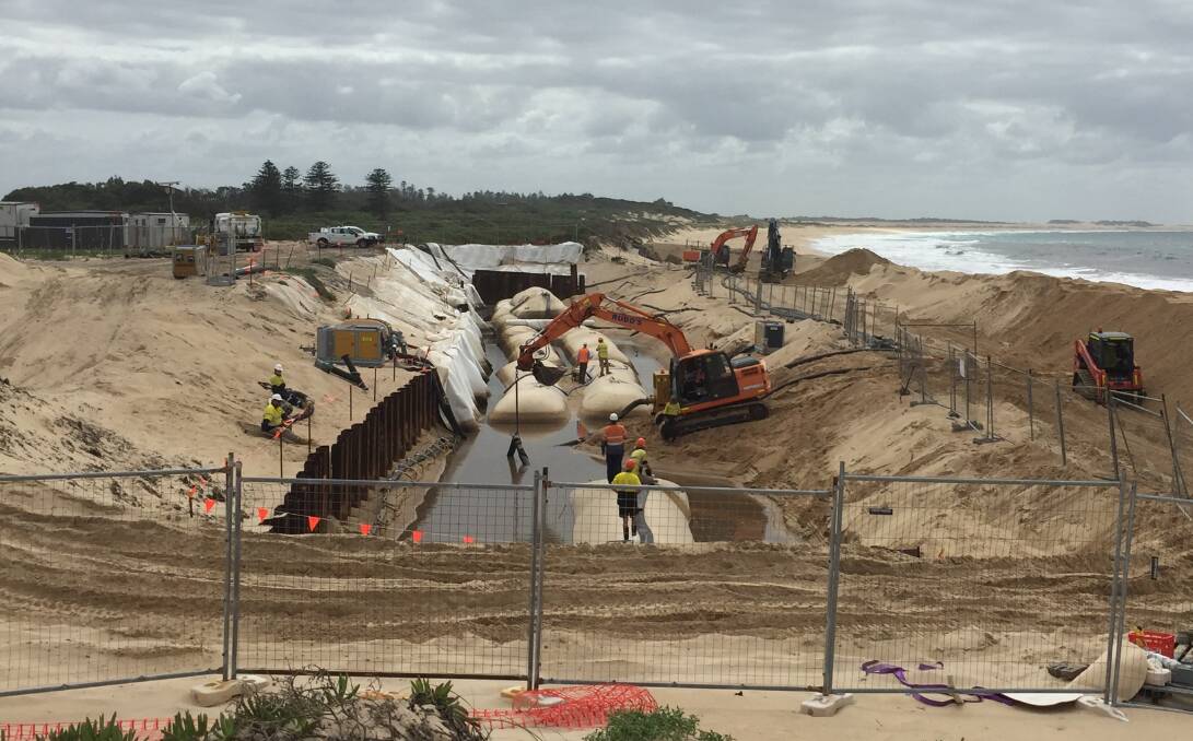 TURNING BACK THE TIDE: Hunter Water is working on a 100-metre sea wall designed to protect a former landfill site at Stockton beach.