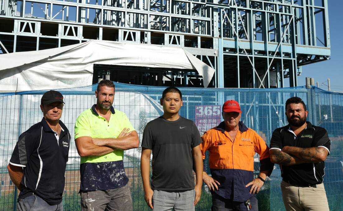 OWED MONEY: Subcontractors David Mansfield, Jake Fuller, Barry Huang, Steve Horton and Vince Di Prinzio outside a former Sehez construction site in New Lambton. Picture: Jonathan Carroll