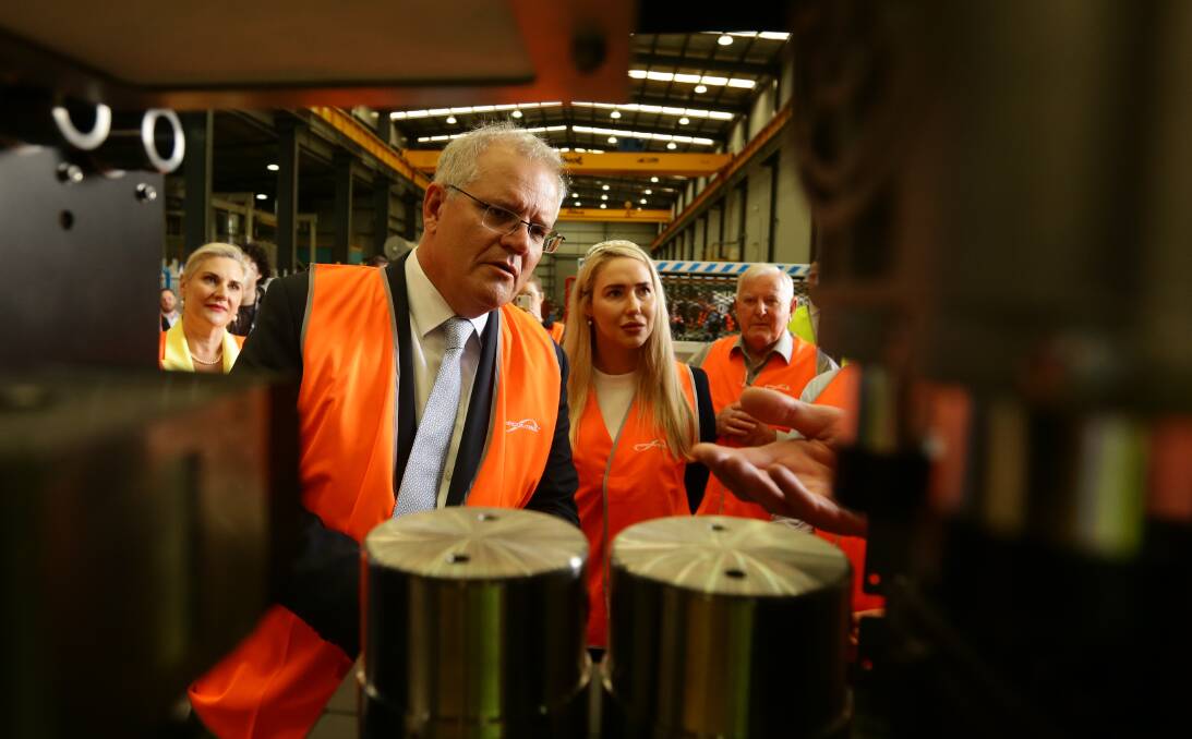 SUPPORT: Scott Morrison and Brooke Vitnell inspect energy storage technology at Ampcontrol in Tomago on Monday. Picture: Jonathan Carroll