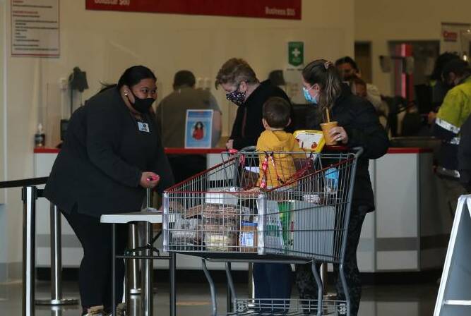 OFF THE LIST: Shoppers at the newly opened Costco at Boolaroo this week. Health officials say the virus is not spreading among customers in shops. Picture: Simone De Peak 