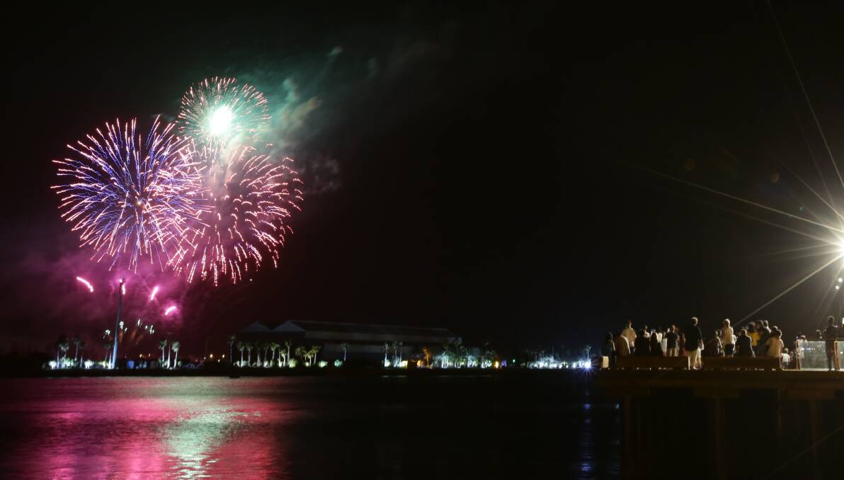 LIGHT SHOW: Revellers watch the Newcastle harbour fireworks on New Year's Eve in 2019. City of Newcastle plans to stage the display again next week. Picture: Jonathan Carroll