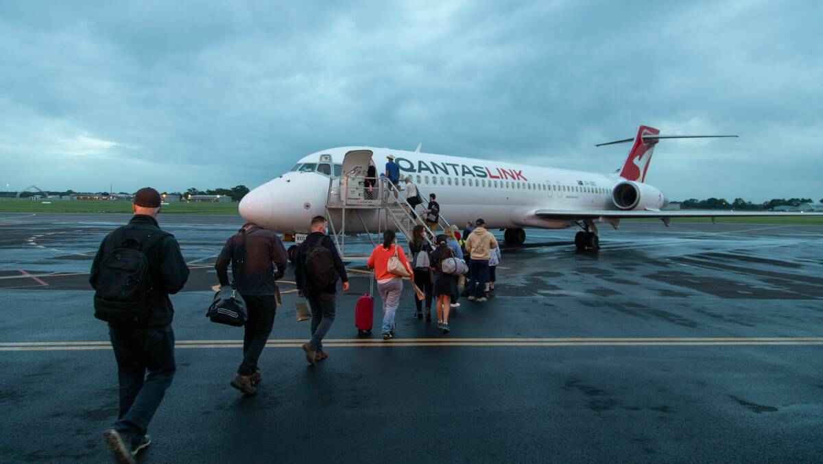 NEW SERVICE: Passengers board the first QantasLink flight on Monday morning.