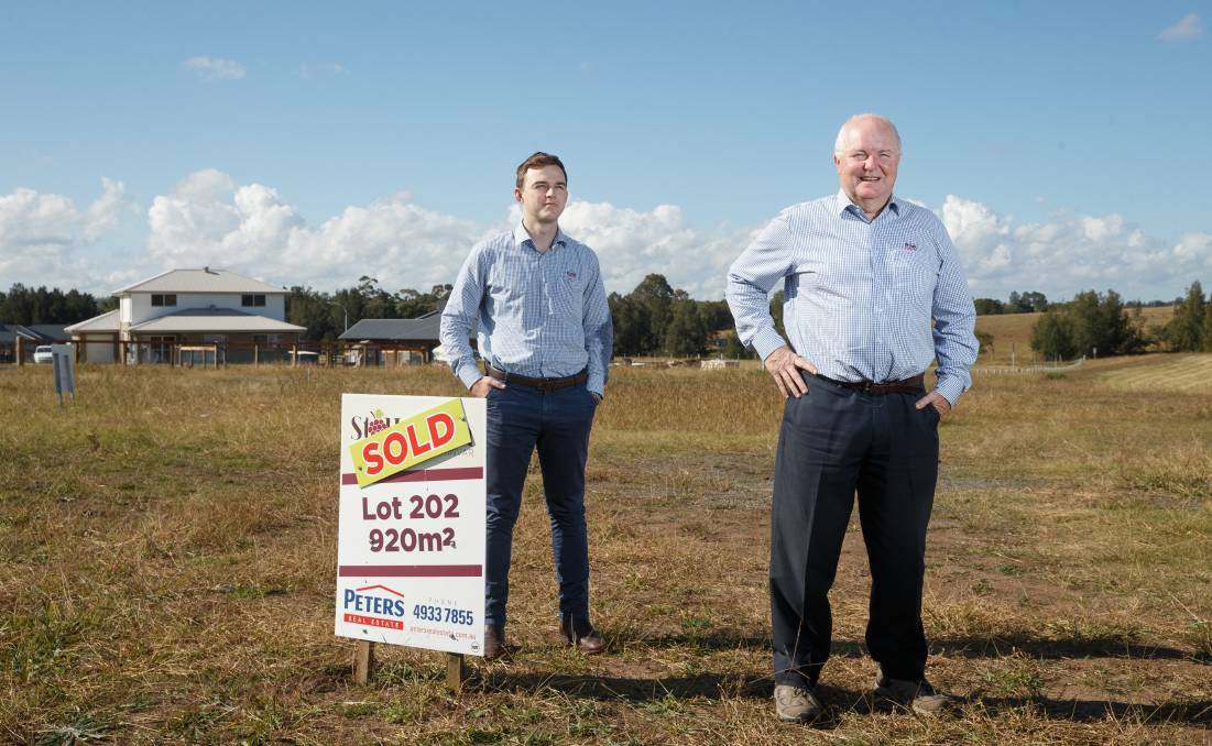 RECORD QUARTER: Maitland real estate agents Lachlan Doyle and Tim Peters at the St Helena subdivision at Lochinvar, where buyers have been camping out to secure a block. Picture: Max Mason-Hubers 