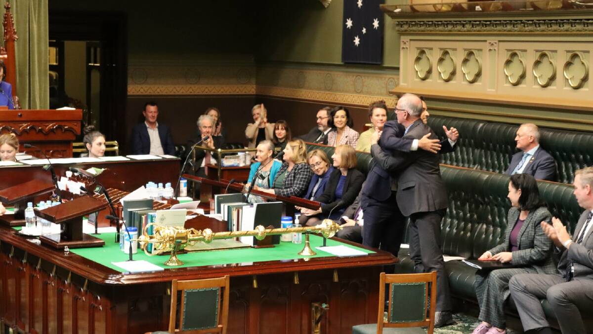 VOTED UP: Alex Greenwich and Greg Piper embrace after the assisted dying bill passed the lower house on Thursday. Picture: NSW Parliament