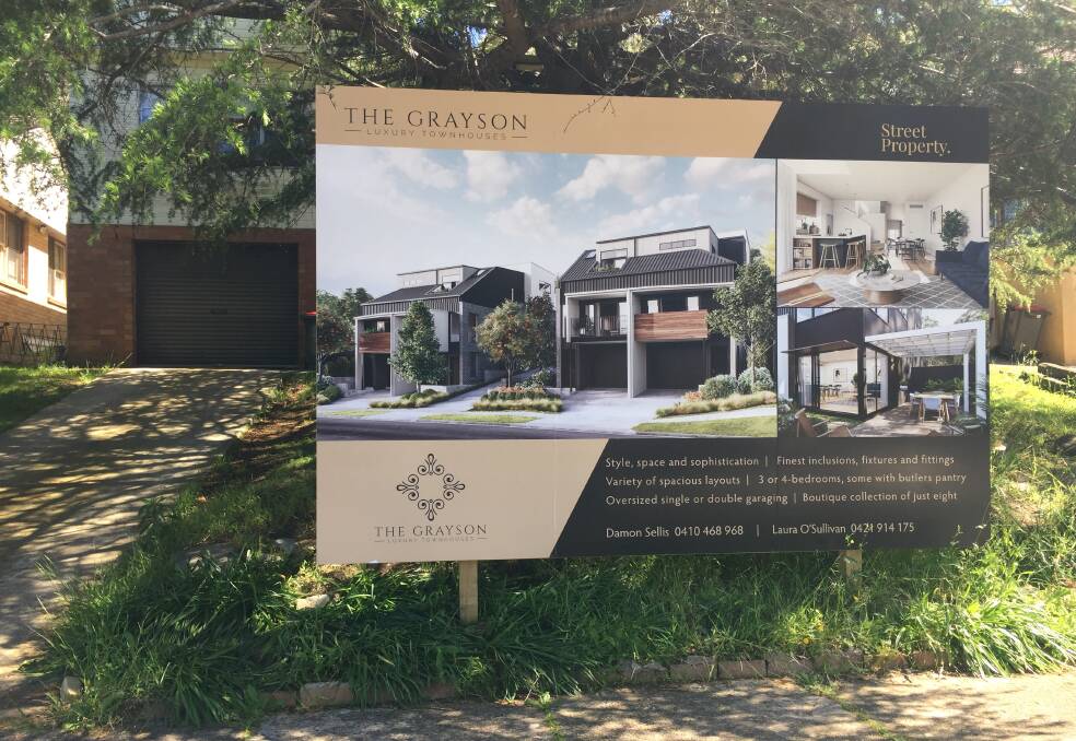 FOR SALE: A sign promoting an eight-townhouse development in Grayson Avenue.