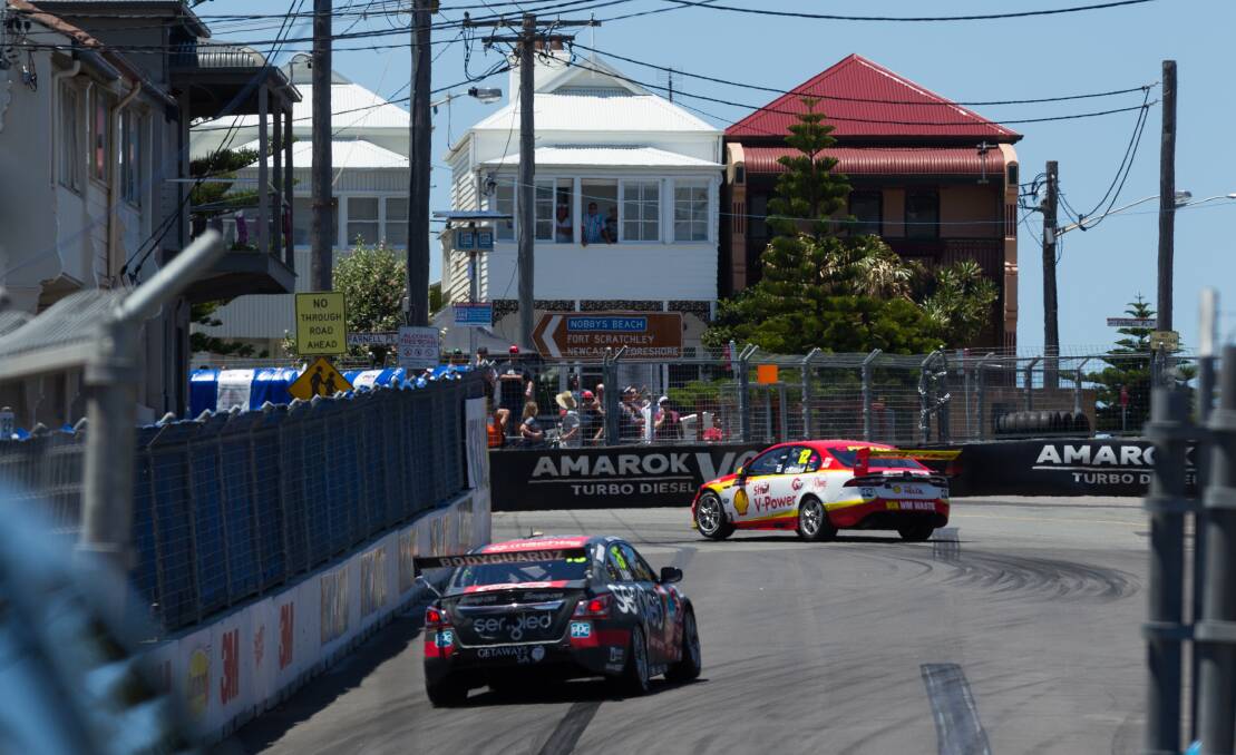 DIVIDED ROAD: Race cars turn from Scott Street into Parnell Place during last year's Supercars weekend. An assessment of the costs and benefits of the race has highlighted fault lines in the city.    