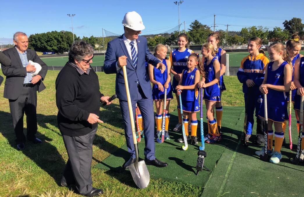 Sports Minister John Sidoti turning the first sod for the Newcastle Hockey Centre redevelopment with Hunter junior representatives on Thursday. 