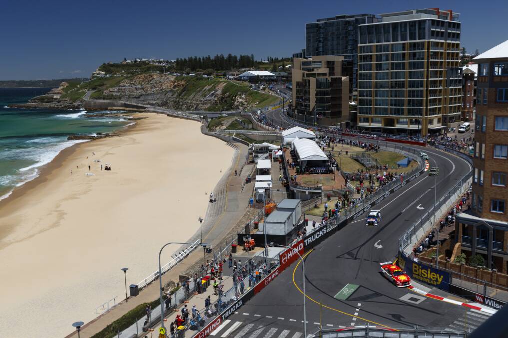 OUT IN FRONT: Scott McLaughlin leads championship rival Shane van Gisbergen into a corner opposite Newcastle beach during practice on Friday. Picture: Mark Horsburgh