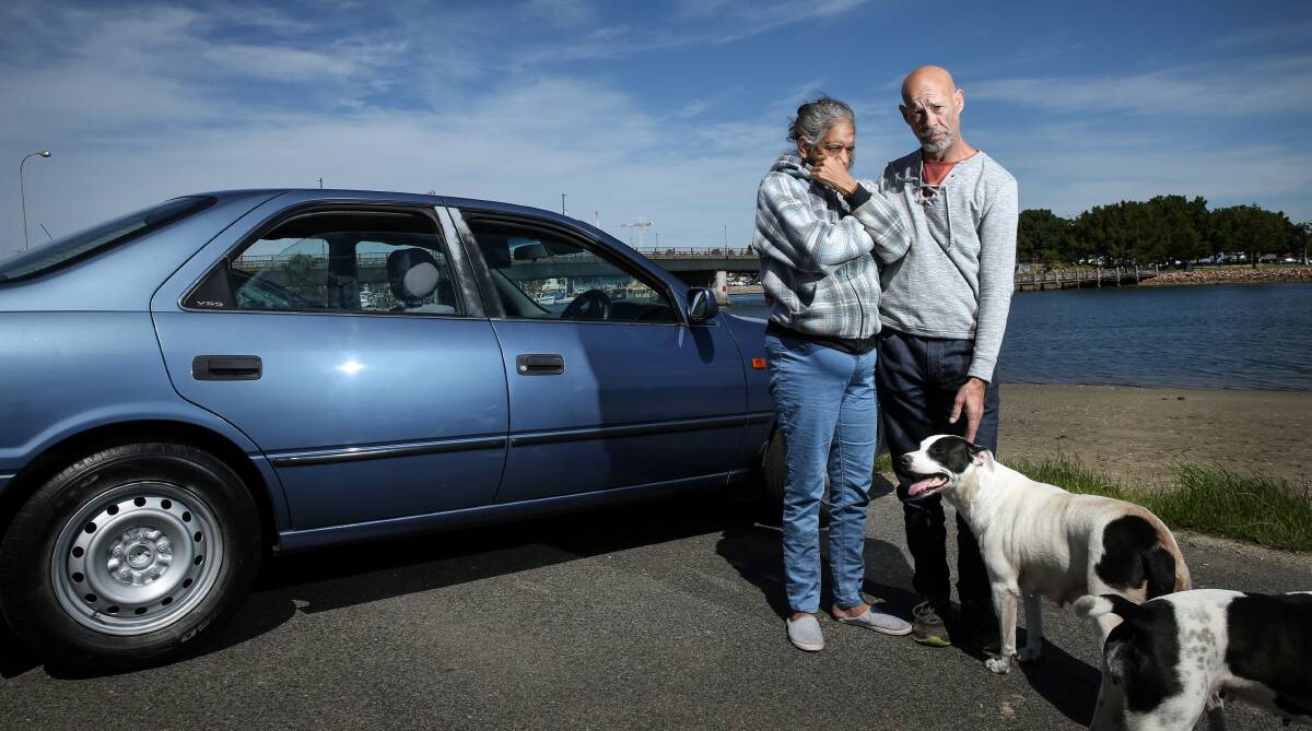 DOING IT TOUGH: Troy Hurst and wife Pauline with their dogs, Bella and Jackie, and their car at Carrington on Thursday. Picture: Marina Neil