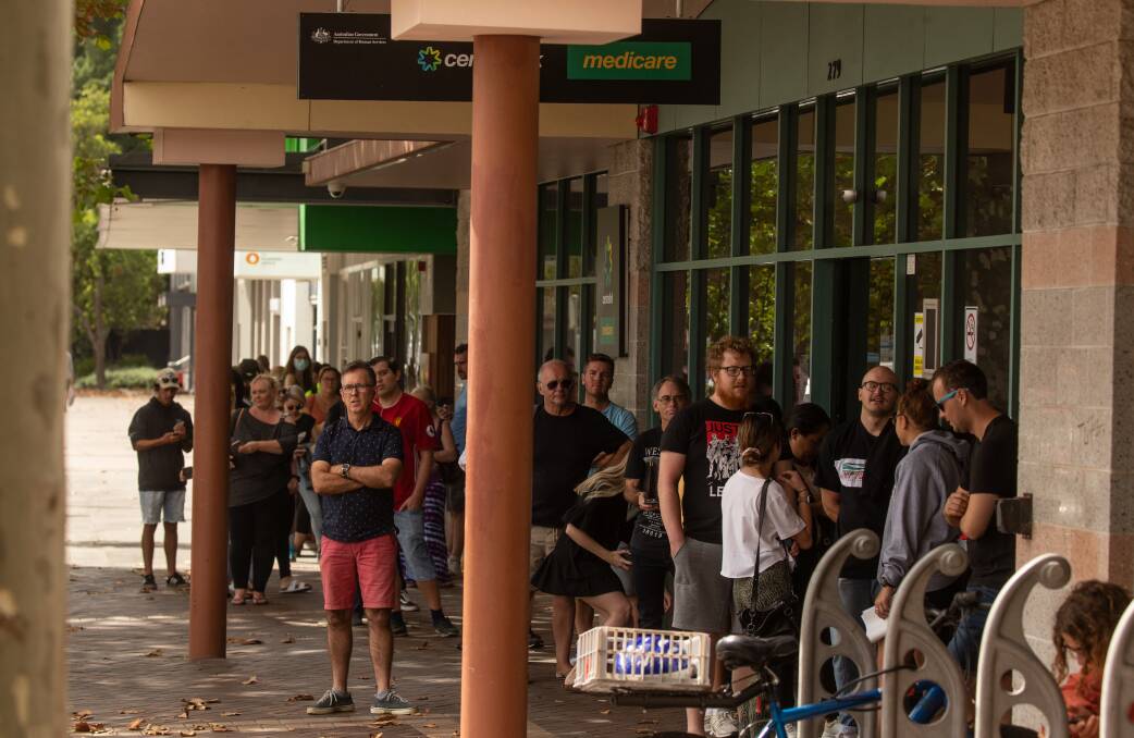 JOIN THE QUEUE: People line up outside the Newcastle Centrelink office on March 23 after the government introduced strict social distancing measures. Picture: Marina Neil