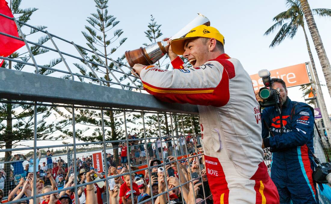 CHAMPION: Ford driver Scott McLaughlin celebrates with spectators beside pit straight on Sunday after clinching his first Supercars championship. Picture: Max Mason-Hubers