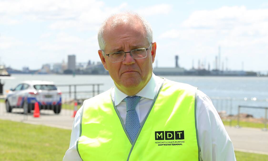 FAN: Scott Morrison wearing a Newcastle container terminal vest while meeting port representatives in March.