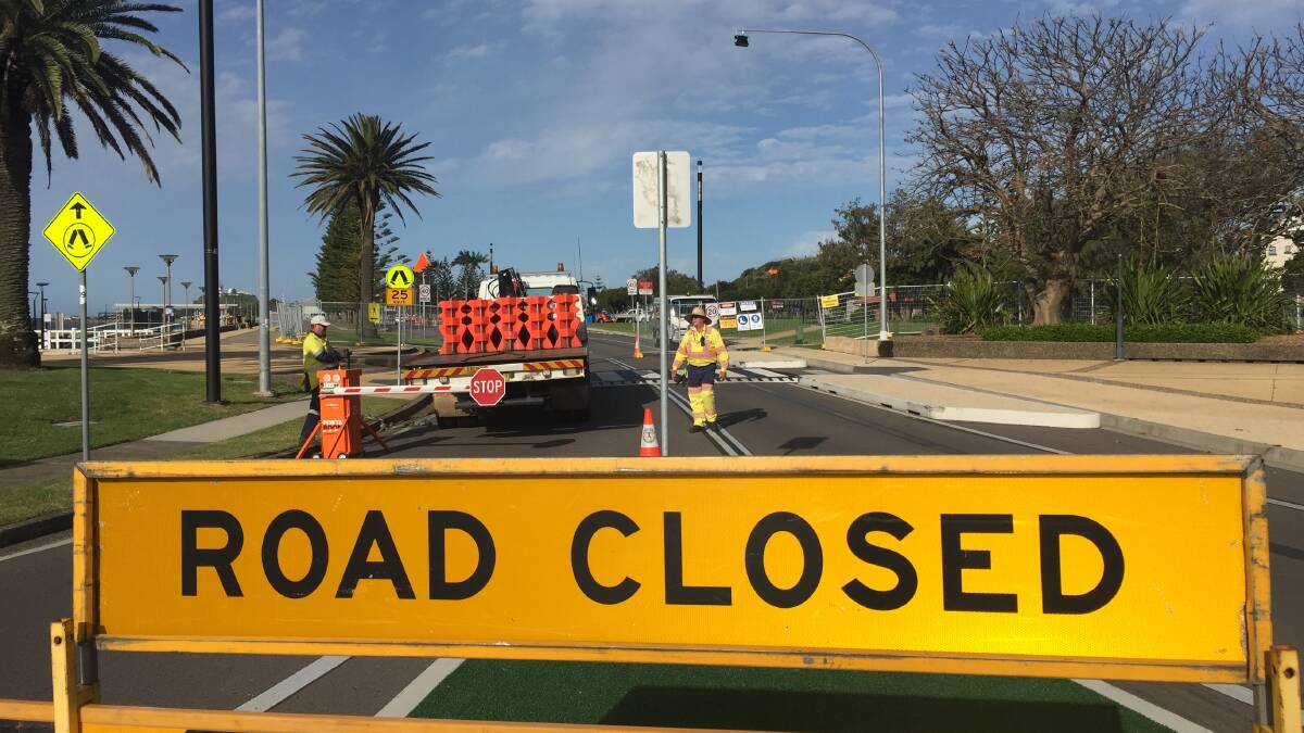 ROAD BLOCK: Workers close Wharf Road to traffic on Monday. It will reopen in two months.