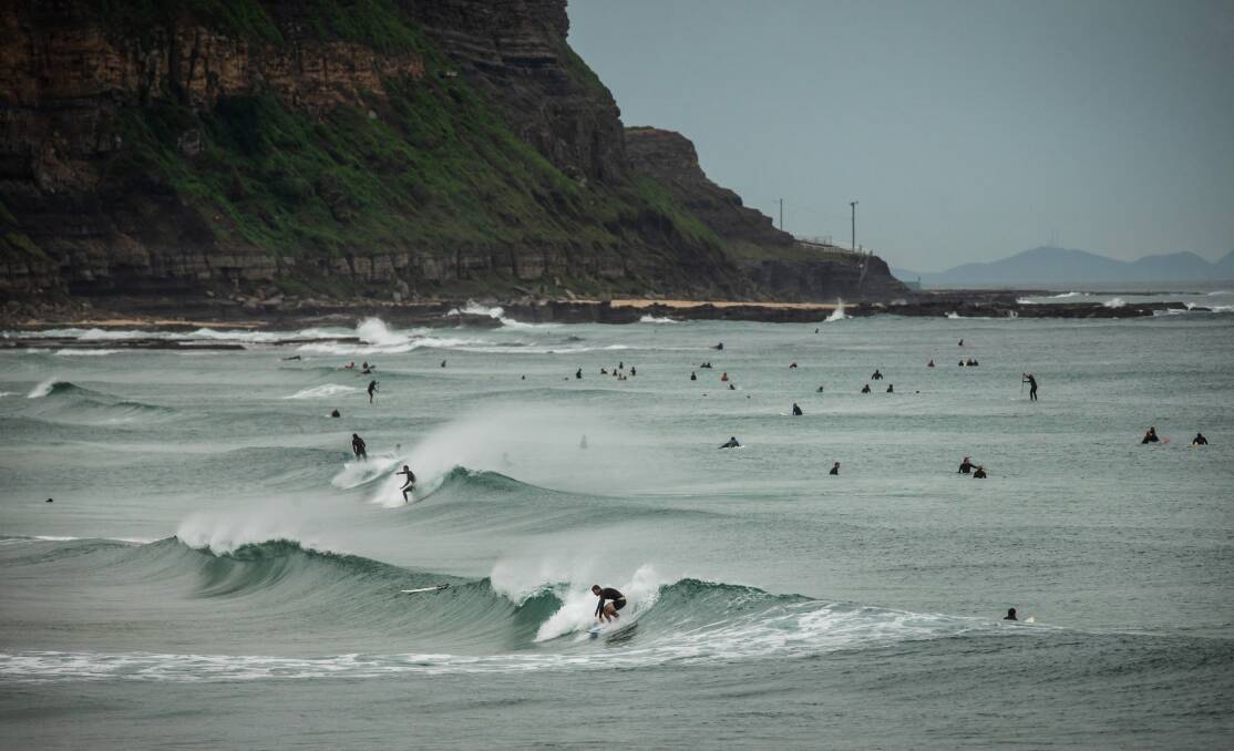 CLOSED: Surfers along the Merewether to Bar Beach stretch on Monday. Picture: Marina Neil
