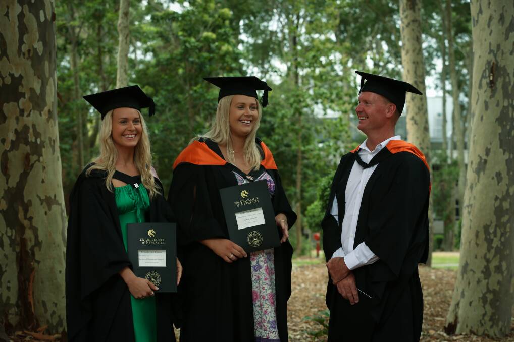 Family affair: Kimberley and Karlee Brunette officially graduated from the University of Newcastle alongside their father, Adrian Brunette, on Monday. They said it had made the day extra special. Picture: Simone De Peak