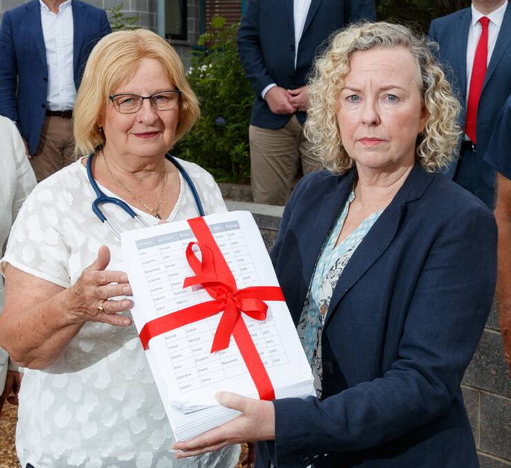 Concerns: Dr Annette Carruthers, one of the founders of GP access, and Sharon Claydon pictured in November with a petition to preserve funding for after hours care. Picture: Max Mason-Hubers