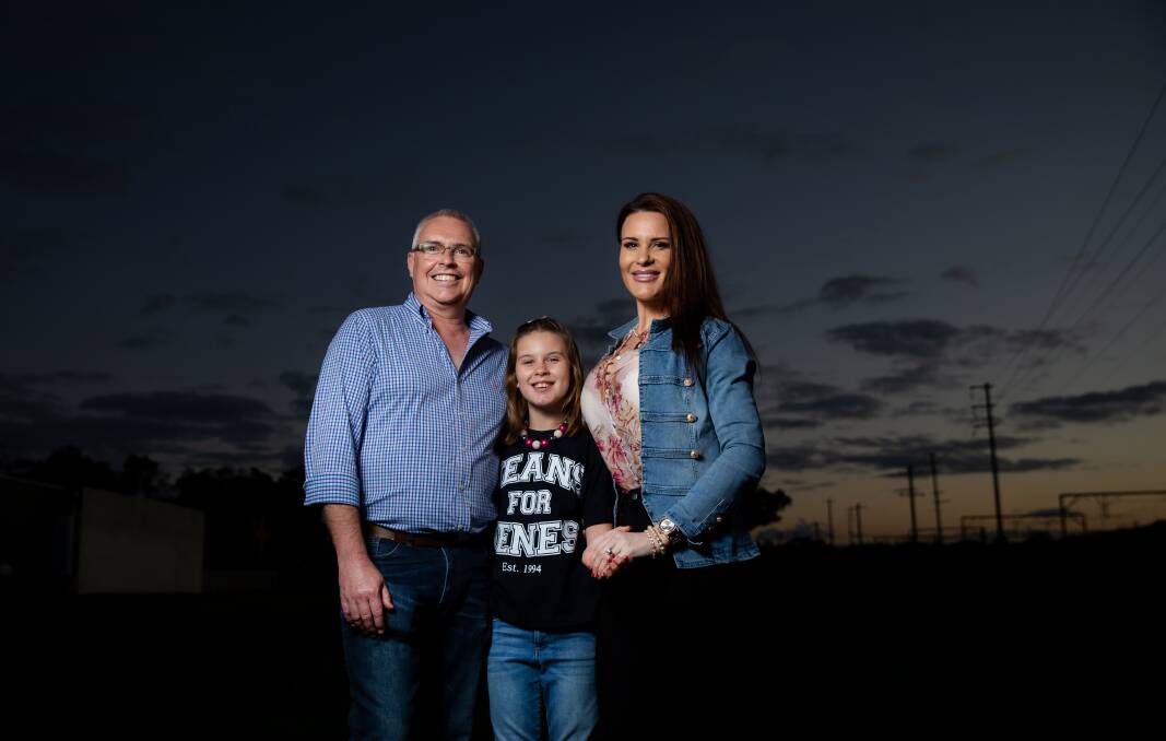 Hope: Mollyjane - also known as MJ - is one of the faces of Jeans for Genes Day on August 7. Pictured with her family, Joe and Jess Rothwell. Picture: Marina Neil 