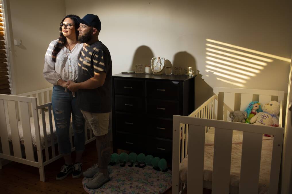 Support: Hayley Castles and Nathan Rae, of Beresfield, in the nursery they had decorated for their identical twin girls, Remy and Lilah. The babies were born at 22 weeks and did not survive. Pictures: Peter Stoop