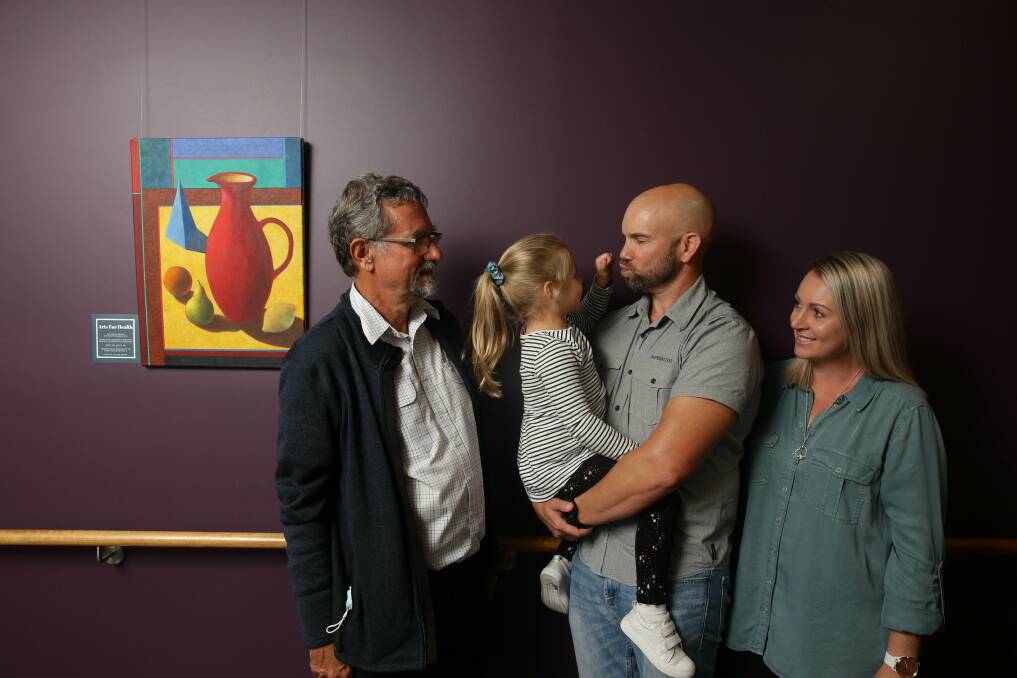 Trusted hand: Dr Henry Murray, left, reunites with Enid, 4, and her parents Philip and Casey Smith. Dr Murray gave Enid a life-saving blood transfusion while she was still in the womb. Picture: Jonathan Carroll