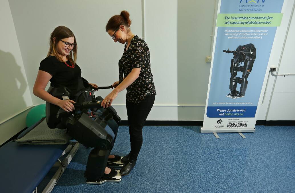 Robot therapy: Karlie Gehrig, an intern at the School of Health Sciences, shows HELLEN in action with PhD student Nicola Postol. Picture: Simone De Peak.