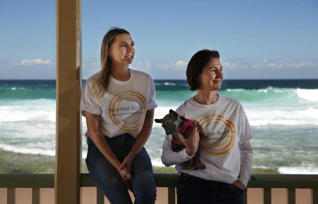 Hope: Rachel Henshaw, right, and her daughter, Taylor Henshaw, hope more people will join their sunrise paddle out at Merewether Beach on Sunday, September 9, ahead of World Suicide Prevention Day. Picture: Simone De Peak
