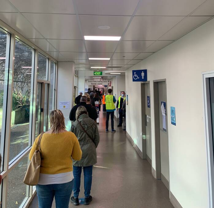 Worth the wait: People queue for the COVID-19 vaccination clinic at John Hunter Hospital. 