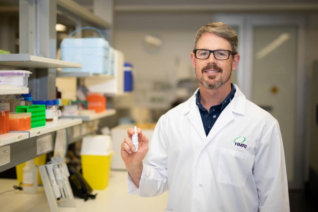 Associate Professor Nathan Bartlett with the nasal spray shown to be effective against the common cold and COVID-19.