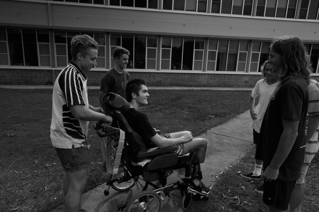Road to recovery: Lawson Rankin with friends Tarj Lyle and Jay Bailey, who helped pull him out of a drain after he crashed in Bail, and with other visiting friends at the Rankin Park Centre. Picture: Max Mason-Hubers
