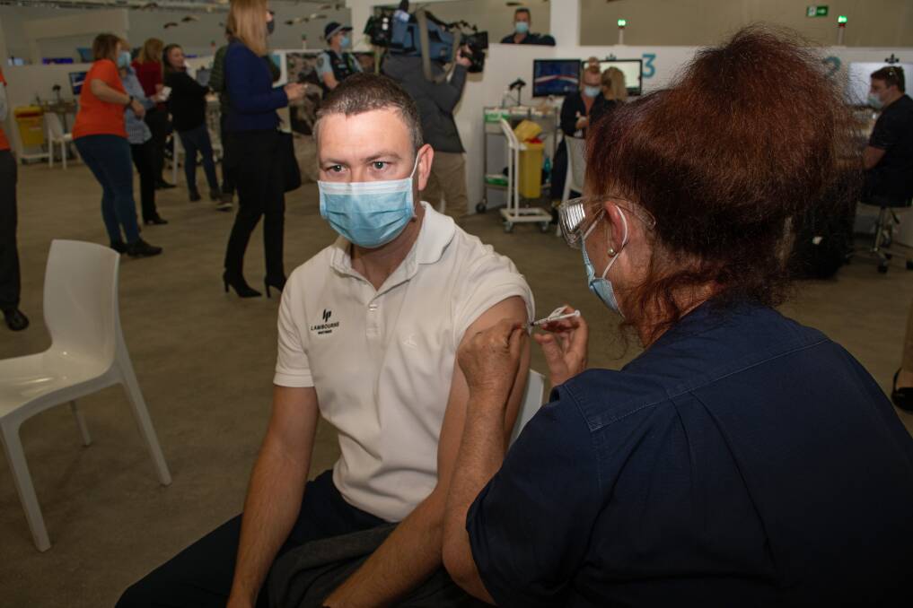 Roll up: Chad Nean, 41, was the first in line to get his jab at the new mass vaccination hub at Belmont on Monday. Picture: Simon McCarthy