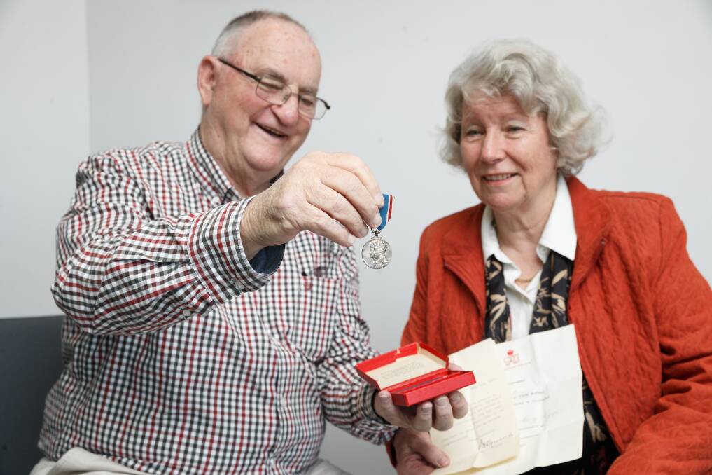 Buried treasure: Vic Levi and Book Fair convenor Lesley Gent, with the coronation medal they found. Picture: Max Mason-Hubers