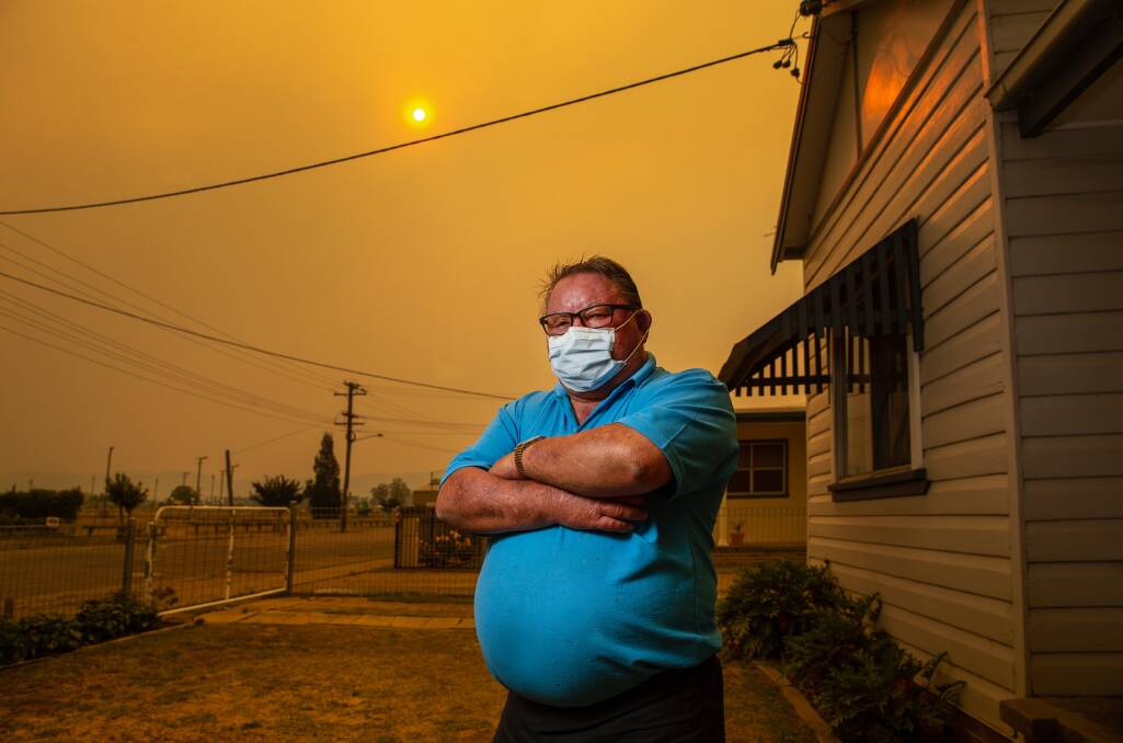 SMOKE HAZE: Brian White, 70, outside his home in Cessnock. He has emphysema, and wore a face mask during the bushfires near Wollombi as a protective measure. He says the smoke affected his throat. Picture: Marina Neil 