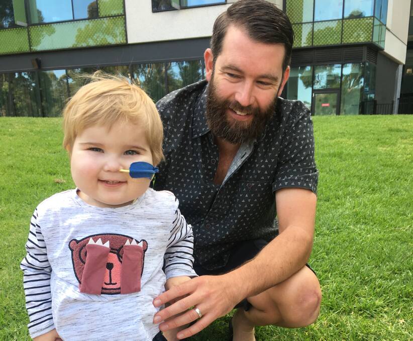 Pumped: Jack and his dad, Patrick Kenny, getting some fresh air outside the hospital before the 30-minute battery life of his life-saving "Berlin heart" runs out. Jack has been on the waiting list for a heart transplant since January.