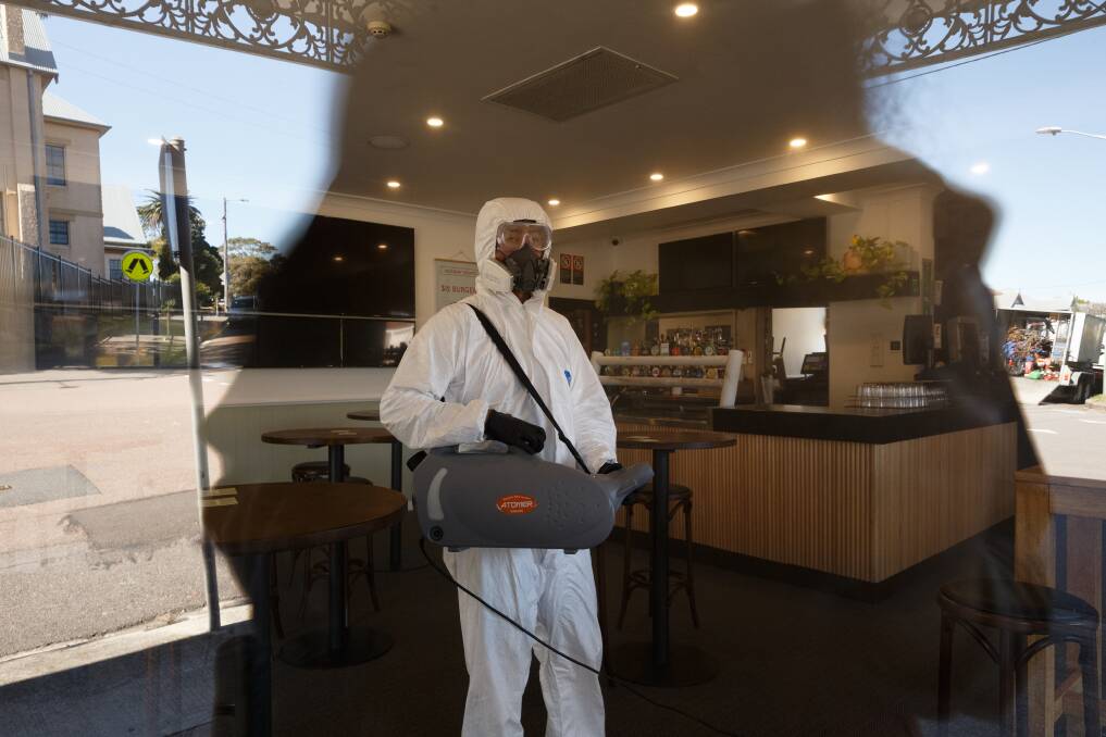 Cleaning crew fumigates a room as part of a deep clean of the Bennet Hotel pub in Hamilton after a COVID case was confirmed as having visited recently. Picture: Max Mason-Hubers 