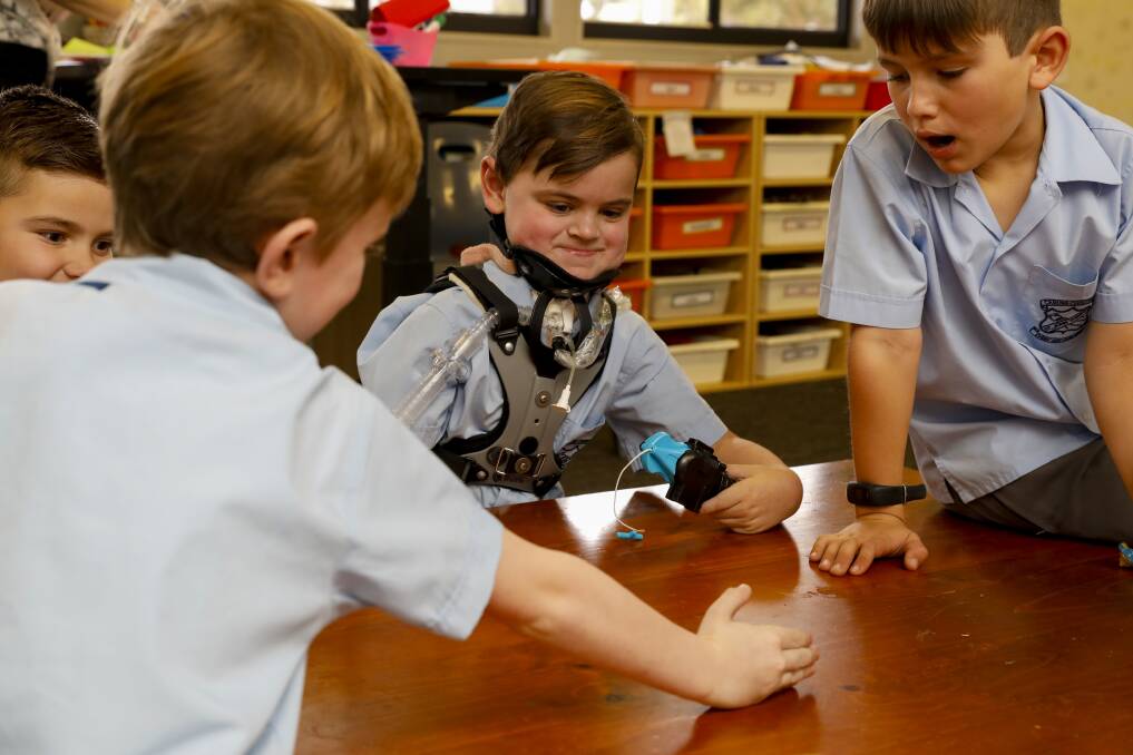 Back at it: Kobe Duck plays Beyblades with his friends, Lukas Dobes, Lachlan Bridges, and Taymin Vaschetty at St John Vianney Primary School.