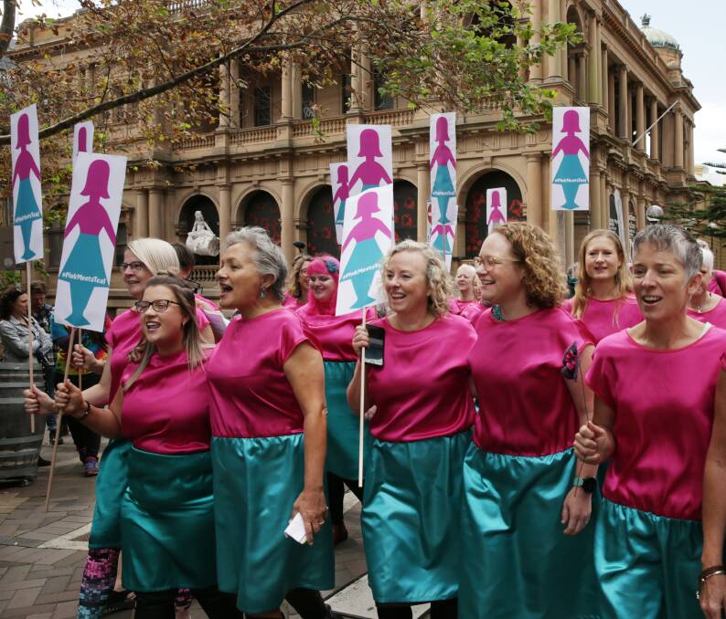 Growing army: Women decked out in the colours synonymous with breast and ovarian cancers marched in Newcastle on Wednesday to launch the Pink Meets Teal campaign, which brings breast cancer survivors together with people fighting ovarian cancer. Pictures: Simone De Peak