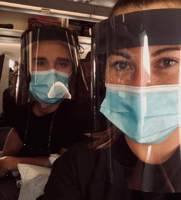 The mask: Tiarne Gillespie and Sean Brocklesby on the first leg of their flight home from London to Doha.