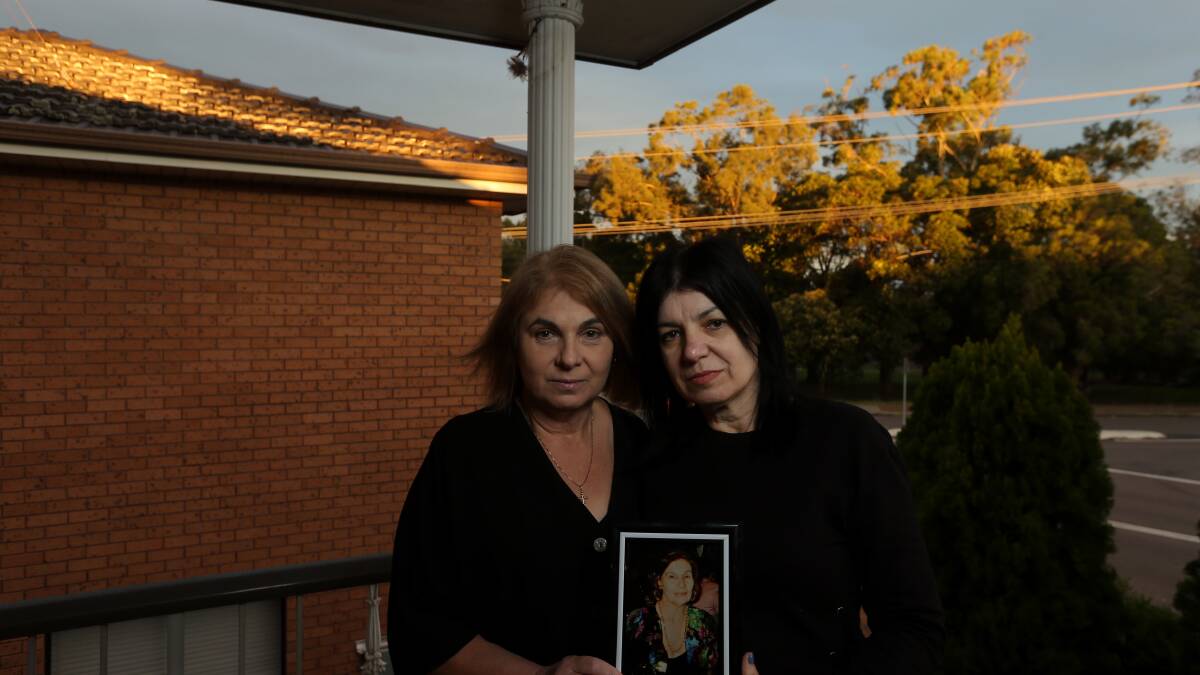 Precious time: Sisters Elka Catalovski and Nada Pajakovski with a framed photo of their mother, Tomanija Cacorovski. They had almost three precious weeks with their mother - together - at Warners Bay Private before their mother died. Picture: Simone De Peak 
