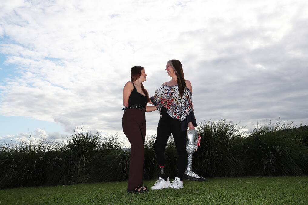 Bond: Thalia Standley, 15, lost part of her arm in a dog attack when she was eight. Getting to know fellow amputee Niki Lea Williams had been comforting when she was feeling alone. They are part of a group who have organised the 2022 Amputee Awareness Ball. Picture: Peter Lorimer