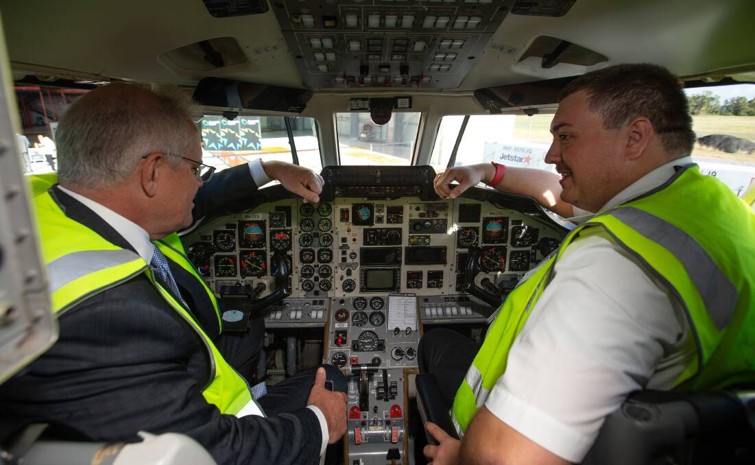 Learning to fly: Scott Morrison gets familiar with the cockpit at Williamtown Airport. Picture: Marina Neil 