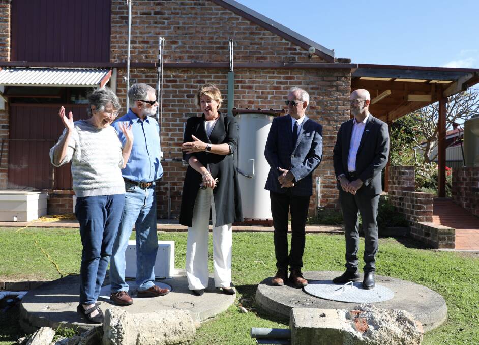 Worth celebrating: Dianne and Winston James standing on their old septic system alongside Water Minister Melinda Pavey, Lake Macquarie MP Greg Piper and Hunter Water MD Darren Cleary. Picture: Alicia Nash.
