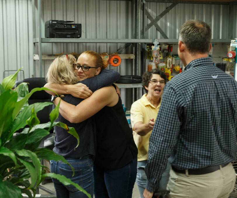 Tears of joy: Rhianna Gorfine hugging Sue Walker at Fullerton Cove on Thursday morning. Picture: Max Mason-Hubers 