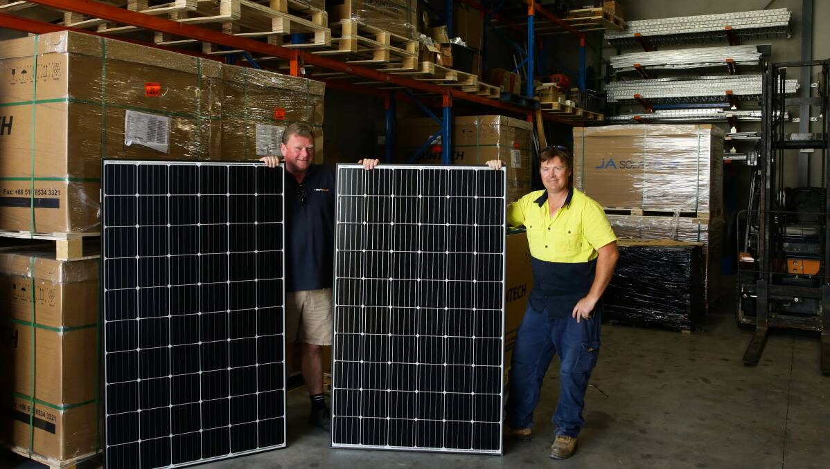 Busy: Newy Solar's Joe Tynan, left, and Mick Geraeds, right, at their Cardiff warehouse. Picture: Jonathan Carroll 
