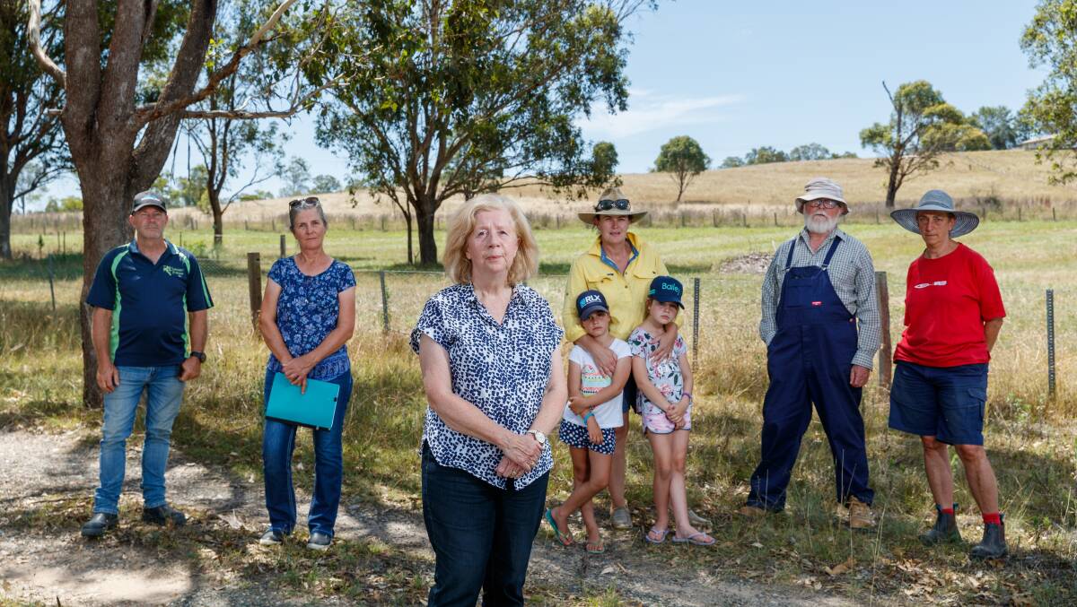 Anne McGowan with her Reedy Creek neighbours Darryl King, Virginia Congdon,
Rebecca, Hattie and Lola Clark, Rob Harris and Dorit Herskovits on Wednesday.
Picture by Max Mason-Hubers