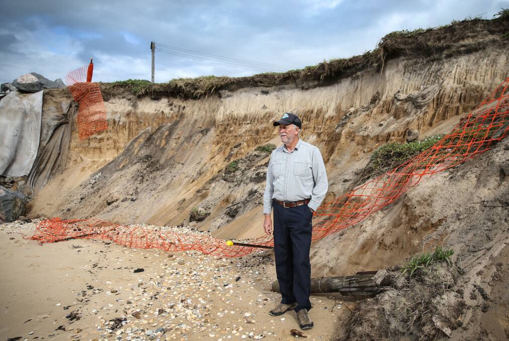 Ron Boyd inspects the severe erosion at Stockon. Picture by Marina Neil